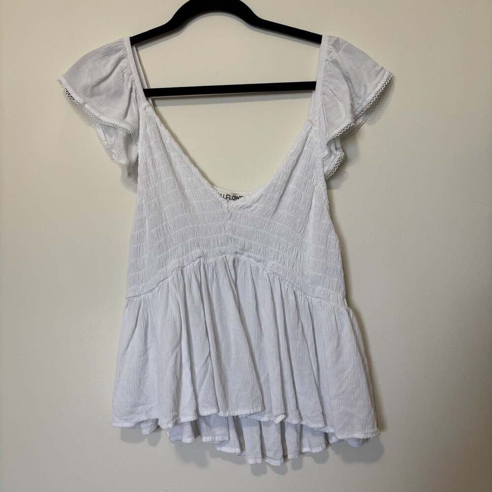 Wallflower white smocked babydoll top with flutter ruffle sleeves